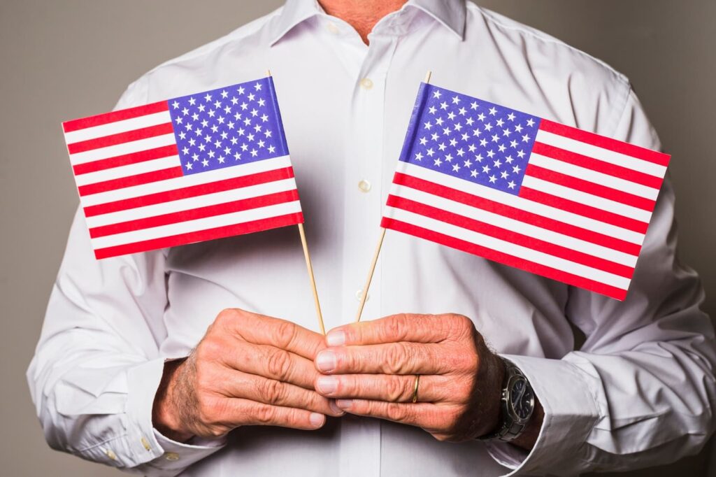 Man's hand holding usa flags in hand